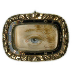 Image of a brooch with a painting of an eye.